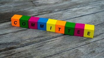 The word "committee" spelled in colored block letters